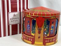 Circular musical gift tin with Nutcracker-themed illustrations and original box