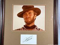 Close-up photo showing Clint Eastwood image and autograph card below it.