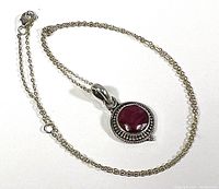 Full view of sterling silver chain with attached pendant showing chain and pendant size and style