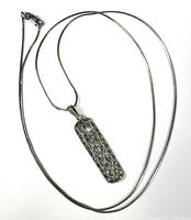 Full view of sterling silver snake chain with attached filigree pendant.