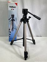 Velbon Videomate 500 tripod fully extended next to original box showing tripod and packaging details.