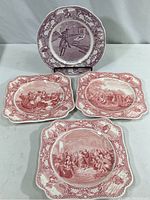 Four vintage colonial-themed collector plates arranged on white surface, showing different historical scenes