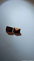Two octagon cut almandine garnet stones shown side by side on a plain background, highlighting their deep red color and polished facets.