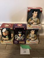 Four CelebriDuck rubber ducks in original packaging: KISS The Demon, two Elvis Presley, and Popeye, stacked on a floor.