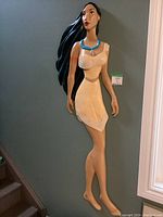 Front view of 5 feet tall 3D plaster Pocahontas figure hanging on wall, showing full length and detail of figure.
