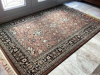 Full overview of the area rug showing the pattern, colors, and condition.