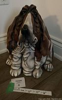 Front view of the Basset Hound figurine showing detailed face and front paws