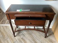 Front view showing drawer partially open beneath the writing surface.