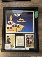 Framed collage with three sections: a large Yellow Submarine graphic with text at top, summary plaque and movie poster below.