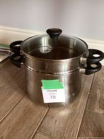 Photo showing the complete assembled pasta cooker set with pot, perforated insert, and glass lid.