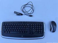 Full view of Logitech wireless keyboard, mouse, and detachable USB dongle with adapter cable