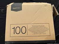 Photo of closed box showing Amazon Basics branding and product details including 100-count quantity