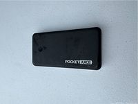Front side of the black Pocket Juice power charging bank.
