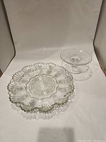 Photo showing both glass serving dishes together on white background for scale and condition.