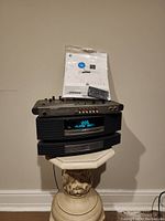 Three stacked units: Radio Shack mixer on top, Bose Wave System in middle, Bose multi-CD changer at bottom, with manual and remote on top.