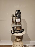 Front view of the Crosley chrome finish payphone featuring rotary style dial and handset.