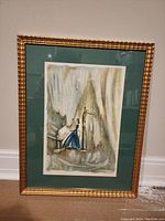 Full view of framed lithographic print showing a man playing violin next to a woman at a piano, with a green mat and gold textured frame.