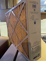 Side angle view of one furnace filter showing diamond wire mesh and pleated filter media.