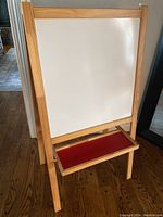 Front side of easel showing whiteboard with red tray attached