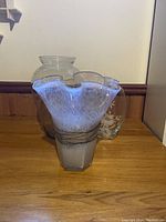 Three large flower vases grouped together showing relative shapes and style