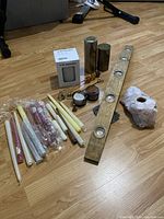 Full lot overview showing candles, wooden votive holder, rose quartz boulder, IKEA candle holders, and candle accessories arranged on floor