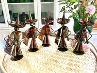 Set of five hand-crafted metal Mexican musician figurines with detailed sombreros, cloaks and musical instruments. Each about 7 inches tall with a hammered metal finish showing brass and copper tones.