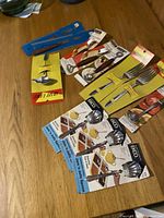 Photo showing a collection of vintage cutlery utensils in original packaging on wood surface from seller