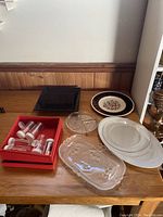 Overall lot showing all serving dishes, trays, and spice jars on a wooden table.