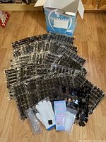 Full view of 24 black shimmer tile panels spread out with accessories and original box.