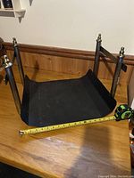 Photo showing the underside and width of the wood rack with measuring tape indicating approx. 18 inches wide.