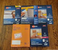 Photo showing five packages of mailing and shipping labels from Avery and Staples, varying sizes and quantities.