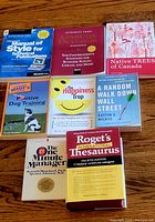Books arranged flat on wooden surface showing covers and titles