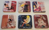 Set of 6 Paris landmark coasters with vintage pin-up style artwork on glossy finish and cork backing shown from top view.