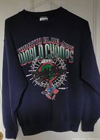 Front view of dark blue sweatshirt with large colorful graphic commemorating 1993 Toronto Blue Jays World Series Championship.