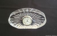 Front angled photo showing the cut crystal pattern and clock face, highlighting crystal clarity and overall shape.