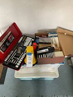General view of the lot setup in garage with socket set and boxes on storage bins.
