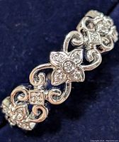 Close-up of band showing central floral motif with surrounding diamonds