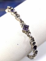 Side angled view of the silver amethyst bracelet showing linked amethyst stones set in silver.