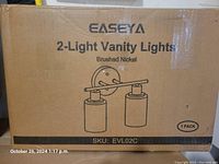 Photo of the boxed Easeya 2-light vanity light with product illustration and branding on the packaging.