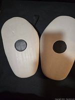 Pair of white punching blockers with black circular targets on front side.