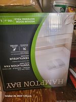 Photo of the Hampton Bay ventilation fan box showing the model BF110HD, white finish, suitable for medium-sized rooms.