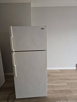 Front view of white two-door refrigerator with top freezer