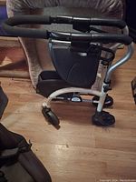 Side view of knee walker showing frame, wheels, handlebars and knee platform