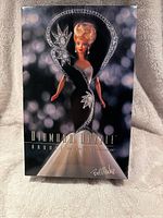 Front of Diamond Dazzle Barbie doll box showing graphic of Barbie posed in black and white gown with glittering accents and the designer's signature.