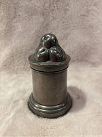 Full view of the antique pewter jelly mold showing the body and decorative top