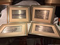 Four framed silver etched artworks displayed together showing detailed rural and nature scenes.