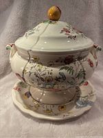 Front view of Spode Gainsborough tureen with lid and underplate on a soft white fabric background.