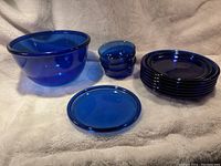 Full display of the set showing large bowl, small bowls, large plates, and one small plate.