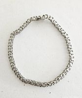 Full view of the .925 silver tennis bracelet laid circular.