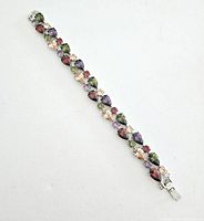 Full image of the bracelet laid out flat showing the variety of colored rhinestone gems and clasp.